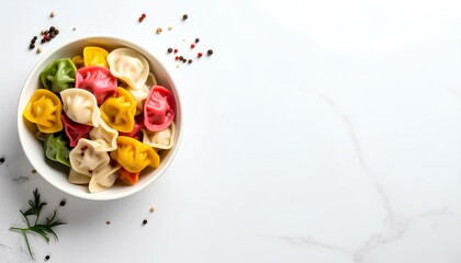 colorful dumplings in a bowl on white background with copy space