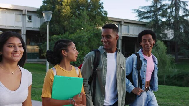 Small group of diverse young Latin American student friends laughing while leaving campus college after classes. Diversity and education lifestyle concept.