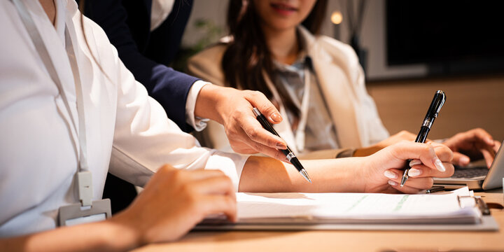 Close up businesswoman hand . Confident youg businesswoman teaching interns or helping new employees in the organization, using laptop.