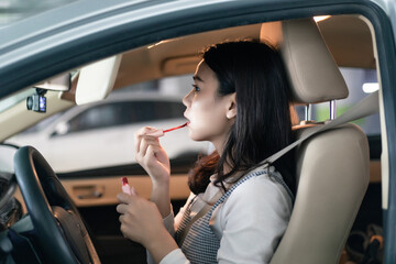 
Young professional women in China are doing their makeup in a small car
