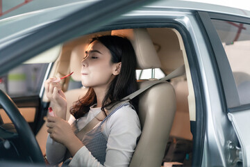 
Young professional women in China are doing their makeup in a small car
