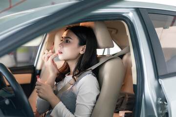 
Young professional women in China are doing their makeup in a small car
