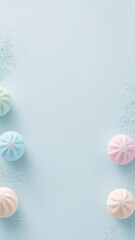 Pastel colored candies arranged on a serene light blue background creating a soft and dreamlike sweet treat composition