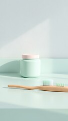 Minimalist spa inspired arrangement with a wooden toothbrush and jar on a soft pastel surface