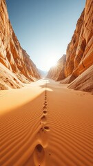 Footprints Lead Through the Sandy Valley Between Towering Rock Formations Under a Clear Sky With Distant Mountain Range and Bright Sun