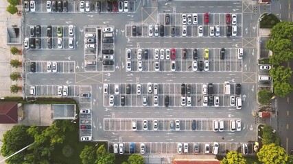City traffic flows through business hotel parking lot during peak hours with aerial photography