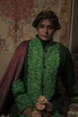 Fototapeta premium A Kashmiri model wearing a handcrafted dress by Kaar Kash, showcasing timeless valley fashion.