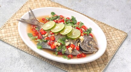 Thai steamed fish served with a bright, punchy  with lots of lime, garlic, chillies, fish sauce and other fragrant aromatics.