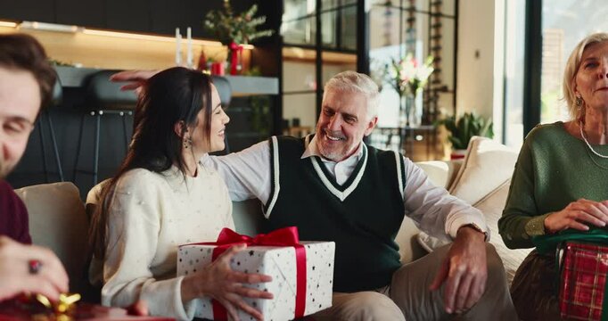 Christmas, hug or senior dad with gift for happy family, support or festive celebration. Care, smile or woman giving xmas present for gratitude, elderly parent or love for holiday tradition in home