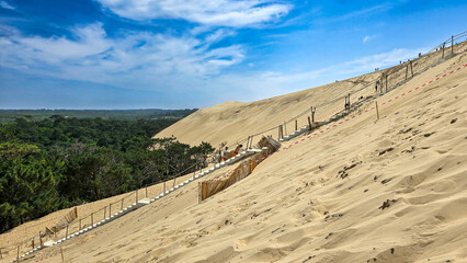 Repair work on the stairs of the highest sand dune in Europe Dune of Pilat on the Arcachon Bay. Grande Dune du Pilat, Landes de Gascogne, France.