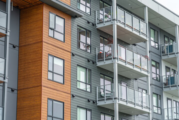 Fototapeta premium Top of modern apartment building with balcony, trees and beautiful landscape in Vancouver, Canada, North America. Day time on June 2025.