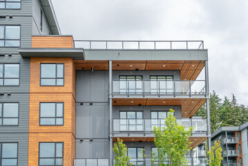 Top of modern apartment building with balcony, trees and beautiful landscape in Vancouver, Canada, North America. Day time on June 2025.