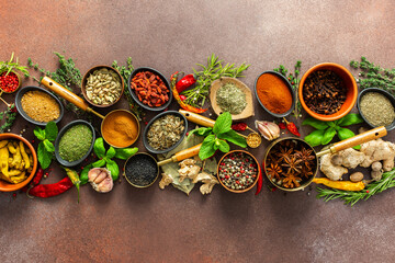 A stunning spread of fresh spices and herbs, meticulously arranged on a deep brown backdrop,...