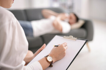 Professional psychologist working with patient in office, selective focus