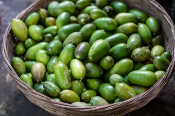 A bunch of green lemon. Many have become a pile together and look like the background.