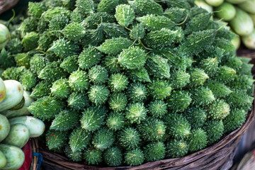 A bunch of green vegetables. Many have become a pile together and look like the background
