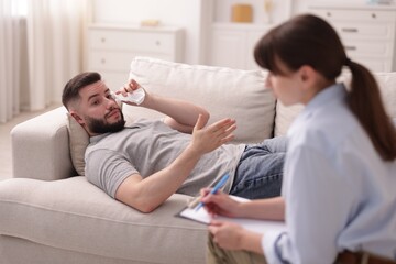 Professional psychologist working with patient in office, selective focus