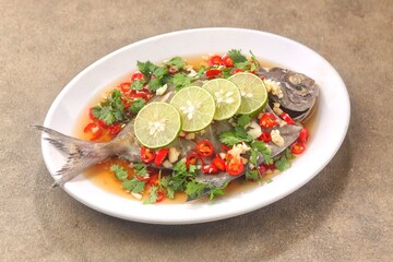 Thai steamed fish served with a bright, punchy  with lots of lime, garlic, chillies, fish sauce and other fragrant aromatics.