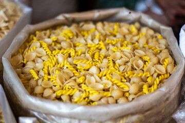 There are many dry foods in a sack, and a part behind it is blurred.