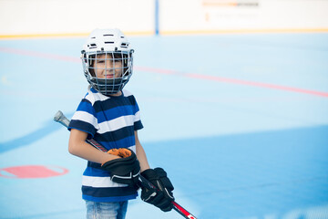 Children playing hockeyball on playground