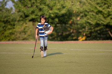 Children playing hockeyball on playground