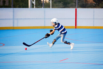 Children playing hockeyball on playground