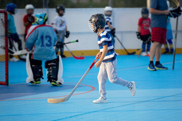 Children playing hockeyball on playground