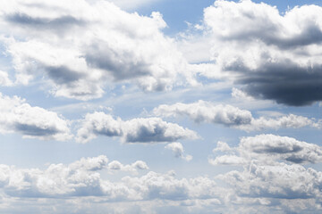 White clouds on blue sky. Natural soft cumulus formation. Peaceful summer weather. Atmospheric light shapes. Scenic outdoor view. Dreamy nature pattern. Background for design or meditation.