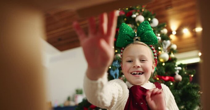 Happy girl, christmas or surprise with gift box below for holiday present or festive giving in home. Excited, child or kid opening package with smile, wow or thank you for santa weekend in house