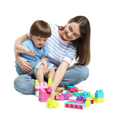 Mother and son playing with building bricks on white background