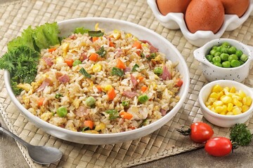 Nasi Goreng Hongkong. Chinese Fried rice is a dish of cooked rice that has been stir-fried in a wok or a frying pan and is usually mixed with other ingredients such as eggs, vegetables, seafood, or me