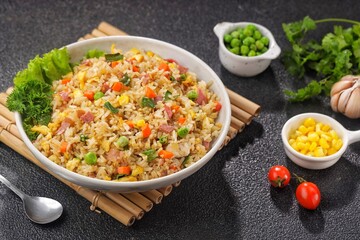 Nasi Goreng Hongkong. Chinese Fried rice is a dish of cooked rice that has been stir-fried in a wok or a frying pan and is usually mixed with other ingredients such as eggs, vegetables, seafood, or me
