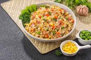Nasi Goreng Hongkong. Chinese Fried rice is a dish of cooked rice that has been stir-fried in a wok or a frying pan and is usually mixed with other ingredients such as eggs, vegetables, seafood, or me