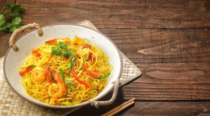 Singapore Mei Fun consists of rice vermicelli seasoned with curry powder, soy sauce and stir-fried with egg, shrimp