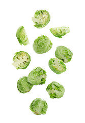 Fototapeta premium Fresh ripe cabbages falling on white background