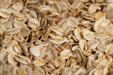 oat flakes from oatmeal , a large amount of oat flakes for quick cooking of porridge in boiled water, close up