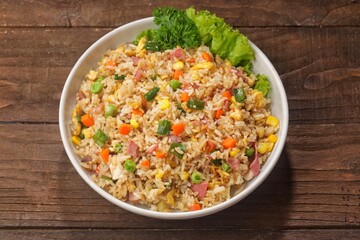 Nasi Goreng Hongkong. Chinese Fried rice is a dish of cooked rice that has been stir-fried in a wok or a frying pan and is usually mixed with other ingredients such as eggs, vegetables, seafood, or me