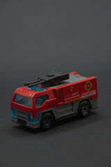Battle car toy red fire truck, black cannon. Suitable for childrens posters, toy packaging, educational materials, and game graphics.