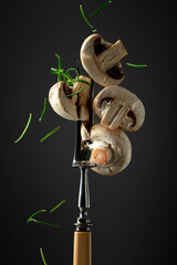 White fresh champignons with rosemary.