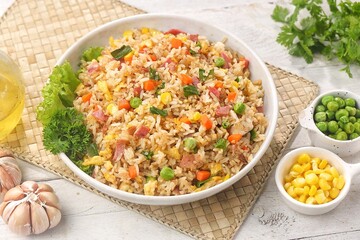 Nasi goreng Hongkong. Chinese Fried rice is a dish of cooked rice that has been stir-fried in a wok or a frying pan and is with other ingredients such as eggs, vegetables, seafood, or meat