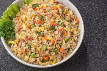 Nasi goreng Hongkong. Chinese Fried rice is a dish of cooked rice that has been stir-fried in a wok or a frying pan and is with other ingredients such as eggs, vegetables, seafood, or meat