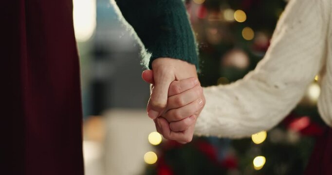 Christmas, holding hands and mother with girl, family and bonding together with holiday season. Closeup, parent and mama with daughter, Xmas and festive with tradition, celebration or home decoration