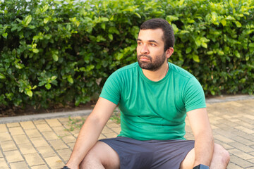 Tired sportsman resting after training for weight loss