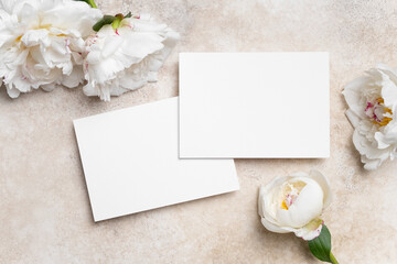 Blank wedding invitation cards mockup with white peony flowers, two cards front and back sides with...