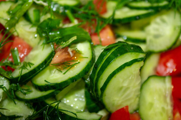 extreme close-up Appetizing fresh cucumber and tomato salad with dill
