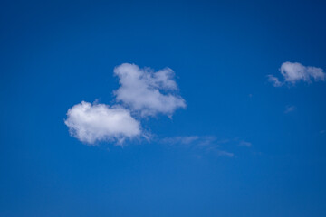 white cumulus clouds in blue sky.