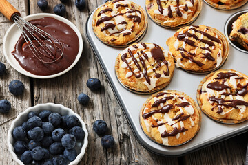 tasty blueberry muffins with lemon chocolate glaze