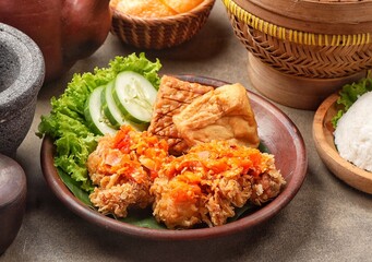 Ayam geprek is a typical Indonesian fried chicken dish with flour that is mashed or mashed with plow chili sauce