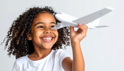 Happy Little Girl Playing with Airplane Toy Dreaming of Travel Adventures.