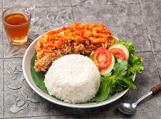 Ayam geprek is a typical Indonesian fried chicken dish with flour that is mashed or mashed with plow chili sauce